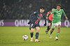 Paris Saint-Germain midfielder Lee Kang-in, left, vies for the ball during the Ligue 1 match against Saint-Etienne at Parc des Princes in Paris on Jan. 12. [AP/YONHAP]