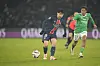 Paris Saint-Germain midfielder Lee Kang-in, left, vies for the ball during the Ligue 1 match against Saint-Etienne at Parc des Princes in Paris on Jan. 12. [AP/YONHAP]