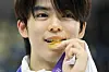Cha Jun-hwan bites his gold medal during the victory ceremony for the men's single free skating at the 9th Asian Winter Games in Harbin, China, on Feb. 13, 2025. [AP/YONHAP]