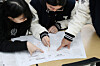 Students check their answers of this year's College Scholastic Ability Test (CSAT) on Nov. 14, 2025, a day after the test took place, at a high school in Daegu. [NEWS1]