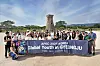 Students pose for a photo against the backdrop of Cheomseongdae during a tour on July 3. [PARK SANG-MOON]