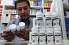 A pharmacy owner arranges Molnuporavir capsules, a Covid-19 treatment, at a pharmacy in Jongno District, central Seoul on May 23. [NEWS1]
