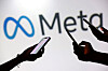 Teenagers pose for a photo while holding smartphones in front of a Meta logo in this illustration taken on Sept. 11, 2025. [REUTERS/YONHAP]