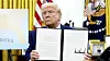 President Donald Trump holds up a signed executive order in the Oval Office of the White House on Feb. 13 in Washington. [AP/YONHAP]