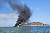 Smoke rises from a fishing boat off the coast of Muan County, North Jeolla, on Feb. 13. [YONHAP]