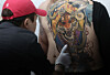 A tattooist displays his ink in Gwangjin District, eastern Seoul, on Aug. 31. [YONHAP]