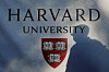 A pedestrian casts a shadow on a Harvard University sign after U.S. President Donald Trump said that his administration was close to a deal with Harvard University, in Cambridge, Massachusetts, Sept. 30. [REUTERS/YONHAP]