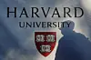 A pedestrian casts a shadow on a Harvard University sign after U.S. President Donald Trump said that his administration was close to a deal with Harvard University, in Cambridge, Massachusetts, Sept. 30. [REUTERS/YONHAP]