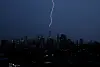A bolt of lightning strikes the spire of One World Trade Center in the Manhattan Skyline during an evening thunderstorm in New York City on July 14. [UPI/YONHAP]