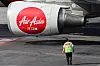 A ground crew member of AirAsia, a subsidiary airline of Capital A, walks on the tarmac of Kuala Lumpur International Airport Terminal 2 in Sepang, Malaysia, Feb. 26, 2024. [REUTERS/YONHAP]