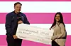 Elon Musk presents a check for $1 million dollars during a town hall March 30, in Green Bay, Wisconsin. [AP/YONHAP]