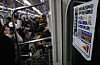 Commuters sit and stand inside a subway car in Seoul on Dec. 1, 2025. [YONHAP]
