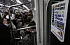 Commuters sit and stand inside a subway car in Seoul on Dec. 1, 2025. [YONHAP]