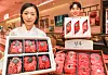 Employees of Hyundai Department Store's Coex branch in Gangnam District, southern Seoul, show hanwoo (Korean beef) gift sets sold ahead of the Lunar New Year holiday. [NEWS1]