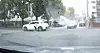 A screenshot from a video of a woman performing a traditional blessing ritual for her new car in the middle of a street [SCREEN CAPTURE]