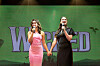 Actors Courtney Monsma and Sheridan Adams perform a song together during a joint interview with the cast of the musical ″Wicked.″ [S&CO]