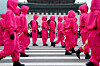 Performers dressed as 'Squid Game' (2021-25) soldiers march in a parade through central Seoul, followed by a fan event with the cast to celebrate the release of the third season of Netflix's hit series on June 28, 2025. [REUTERS/YONHAP]
