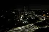 Cars zip past dark buildings during a power outage in Santiago, Chile, Tuesday, on Feb. 25. [AP/YONHAP]