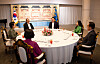 President Yoon Suk Yeol, center right, and former President Lee Myung-bak, center left, chat during a dinner meeting at the official presidential residence in Seoul on Monday evening. [PRESIDENTIAL OFFICE]