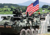 U.S. Stryker armored vehicles stationed in Korea and Korean K200 armored vehicles cross a floating bridge during a combined arms river-crossing exercise held in Yeoju, Gyeonggi, on Aug. 27. [YONHAP]