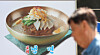 A pedestrian walks by a store selling naengmyeon (cold noodles) in Mapo District, western Seoul, on June 17. [YONHAP]