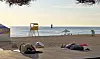 Two people sleep at a beach in Gangwon on August 7, with tropical nights having continued for 19 consecutive days. [YONHAP]