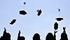 Ewha Womans University graduates toss their caps into the air in Seodaemun District, western Seoul, on Feb. 24. [NEWS1]