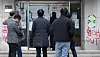 Dongduk Women's University officials walk into the university building, ahead of the meeting with the university student council on Thursday. [NEWS1]