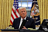 U.S. President Donald Trump signs documents as he issues executive orders and pardons for Jan. 6 defendants in the Oval Office at the White House on Inauguration Day in Washington ON Jan. 20. [REUTERS/YONHAP]