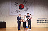 A family of naturalized Korean citizens take a commemorative photo with a Ministry of Justice official on Aug. 12, 2025. [YONHAP]