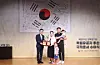 A family of naturalized Korean citizens take a commemorative photo with a Ministry of Justice official on Aug. 12, 2025. [YONHAP]