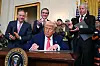 U.S. President Donald Trump signs an executive order at the White House in Washington on April 8. [AFP/YONHAP]