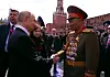 Russian President Vladimir Putin, left, and Kim Yong-bok, deputy chief of the General Staff of the Korean People's Army, shake hands during Russia's Victory Day celebration on May 9. [SCREEN CAPTURE]