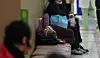 An elderly patient lies on a bench as she waits to see a doctor at a university hospital in Daegu on Friday. [YONHAP]