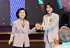 Seol Nan-young, spouse of conservative People Power Party presidential candidate Kim Moon-soo, left, and Kim Hye-kyung, spouse of liberal Democratic Party presidential candidate Lee Jae-myung, hold hands during a Buddhist event held at Shilla Hotel in central Seoul on May 12. [YONHAP]