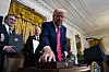 U.S. President Donald Trump hands out pens after signing executive orders during a ceremony at the White House in Washington on April 8. [UPI/YONHAP]