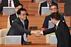 Acting President Choi Sang-mok, left, and National Assembly Speaker Woo Won-shik shake hands during a plenary session at the National Assembly in Yeouido, western Seoul, on Feb. 10. [YONHAP]