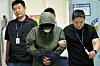 A 49-year-old man accused of killing his wife and children by driving their car into the sea is escorted to a detention warrant hearing at the Gwangju District Court on June 4. [YONHAP]