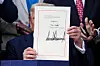 U.S. President Donald Trump presents the sweeping spending and tax legislation, known as the ″One Big Beautiful Bill Act,″ after he signed it, at the White House in Washington, D.C., U.S., July 4, 2025. [REUTERS/YONHAP]