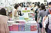Parents line up to buy learning materials and picture books for children at a kids fair in Coex, Gangnam District, southern Seoul on July 10. [YONHAP]