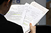 A job seeker reads documents in preparation for an on-site interview at a job fair at Dongdaemun Design Plaza (DDP) in Seoul on Aug. 20. [YONHAP]