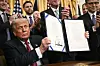 US President Donald Trump displays the GENIUS Act, which codifies the use of stablecoins — cryptocurrencies pegged to stable assets like the dollar or U.S. bonds -- after signing it in the East Room of the White House in Washington on July 18. [AFP/YONHAP]