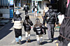 A family of parents and children is seen on a street in Seoul on Feb. 23. [YONHAP]