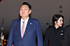 President Yoon Suk Yeol, left, and first lady Kim Keon Hee arrive at Wattay International Airport in Vientiane, Laos, on Oct. 9, 2024. [YONHAP]