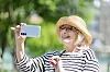 A woman takes a selfie on a sunny afternoon in central Seoul on May 12. [YONHAP]