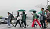Pedestrians with umbrellas cross Sejong-daero, a street in Jongno District, central Seoul, on June 16 as rain pelts the country. [YONHAP]