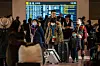Tourists walk through the international arrival lobby at Haneda Airport in Tokyo on Jan. 14. [AFP/YONHAP]