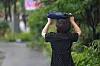 A pedestrian uses a bag to avoid the rain while walking near near Gwanghwamun Square on June 16. [YONHAP]