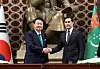 Korean President Yoon Suk Yeol, left, and Turkmen President Serdar Berdimuhamedow shake hands during a joint press briefing on the results of their bilateral summit in Ashgabat, Turkmenistan, Monday. [JOINT PRESS CORPS]