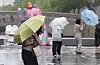 A person with an umbrella walks in rain in downtown Seoul on June 20. [YONHAP]